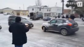 Cars and buses brave ice covered road in Azerbaijan