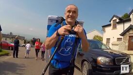 Teacher carries washing machine up mountain