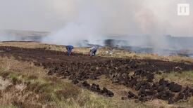 Galway locals stack turf as gorse fires approach
