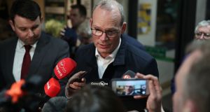 Tánaiste Simon Coveney speaks to the media  at the Nemo Rangers GAA Club in Cork on Sunday. Photograph: Yui Mok/PA Wire