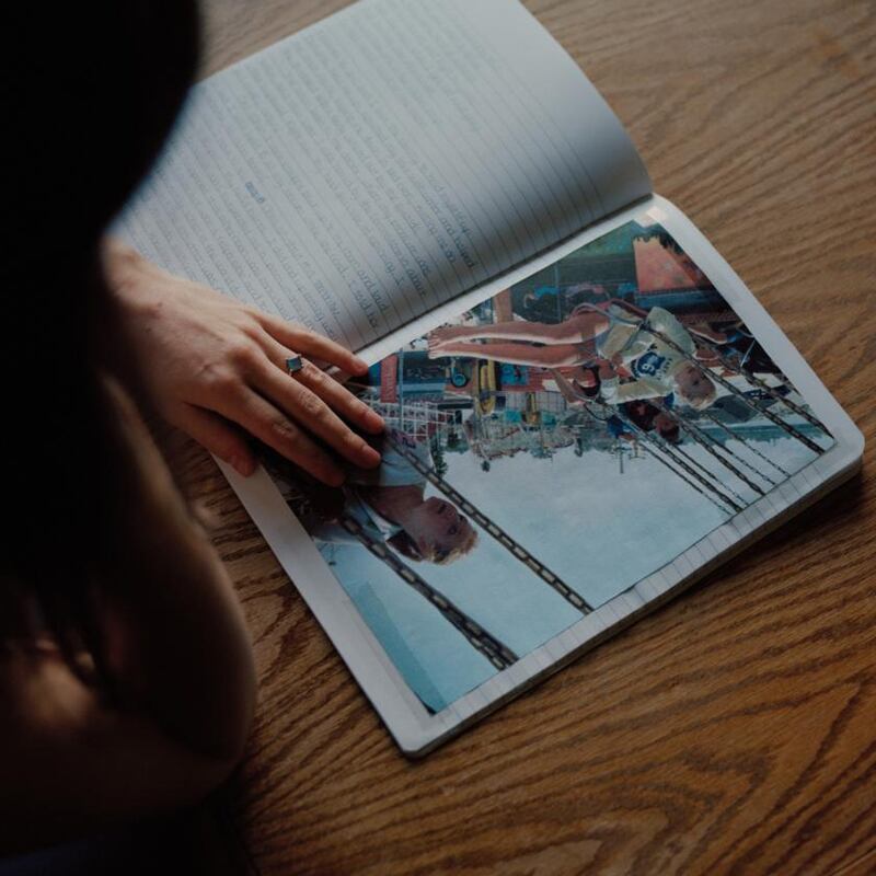 Amanda Knox flips through a journal she kept in prison. Photograph: Ricardo Nagaoka/New York Times