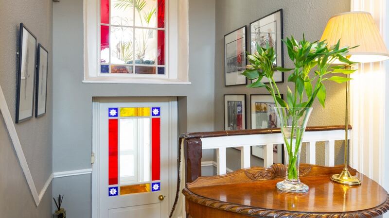 Landing with view of stained-glass panels