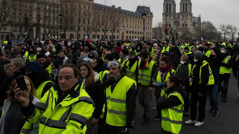 Protesters walk alongside the Seine river during a ‘yellow vests’ protest in Paris, France. Photograph: Ian Langsdon/EPA
