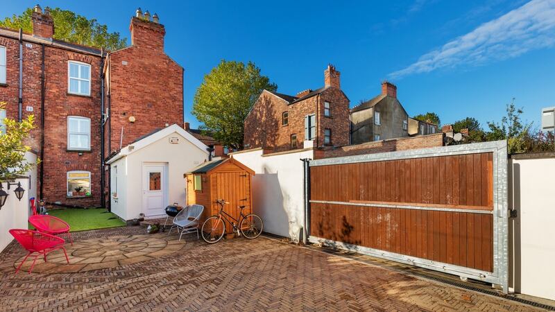 Artificial lawn and cobble-locked paving with off-street parking for up to two cars behind electronic gates.