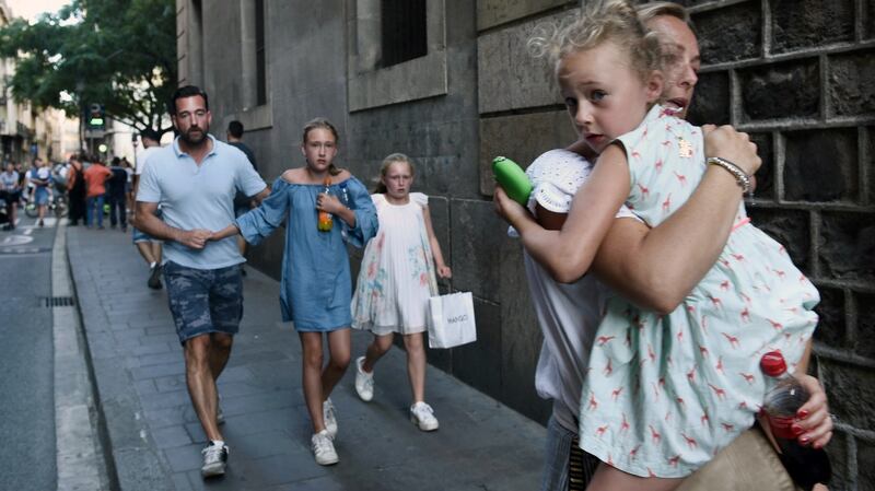 People flee the scene in Barcelona on  Thursday. Photograph: AP