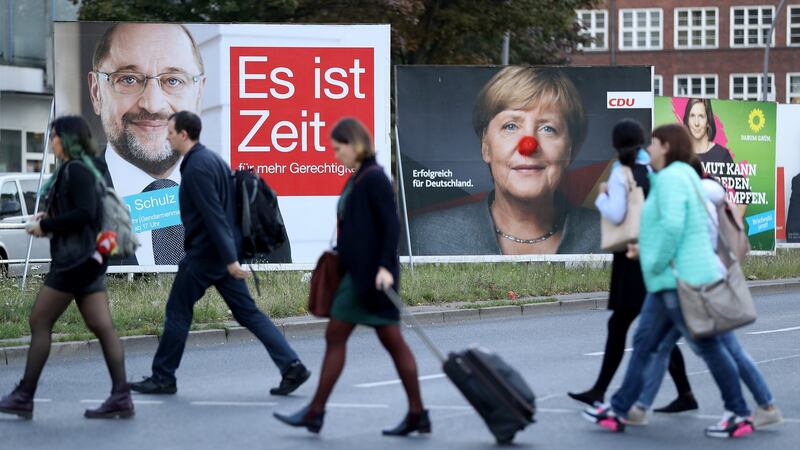 German Chancellor and Christian Democrat  Angela Merkel’s face  is decorated with a red clown’s nose on an election  billboard in Berlin ahead of the German election on September 24th. A board with the image of German Social Democrat  candidate Martin Schulz is on the left. File photograph: Sean Gallup/Getty Images