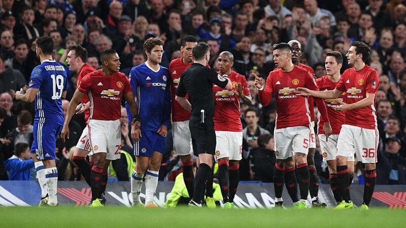 Manchester United players protest after Ander Hererra’s red card at Stamford Bridge. Photo: Justin Tallis/Getty Images