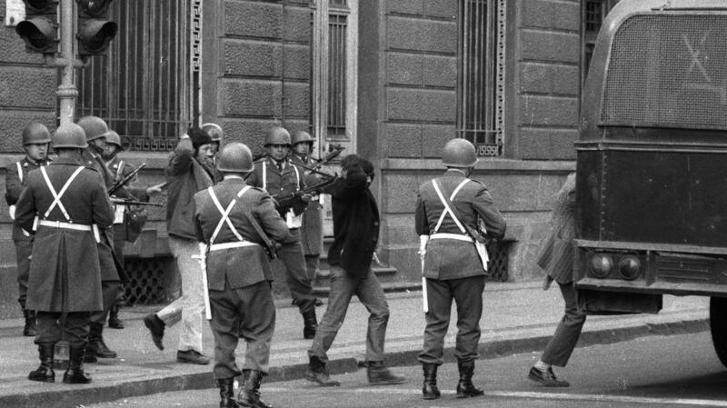 A group of Salvador Allende’s bodyguards are held prisoners by Carabineros, across the street from La Moneda. All  were killed later. The photograph was taken during the aftermath of the coup d’etat led by Commander of the Army General Augusto Pinochet. Photograph:  Horacio Villalobos/Corbis via Getty Images