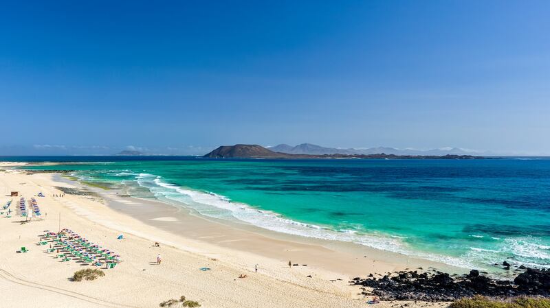 Beautiful turquoise water and white sand of Grandes Playas de Corralejo on Fuerteventura, Canary Islands, Spain,