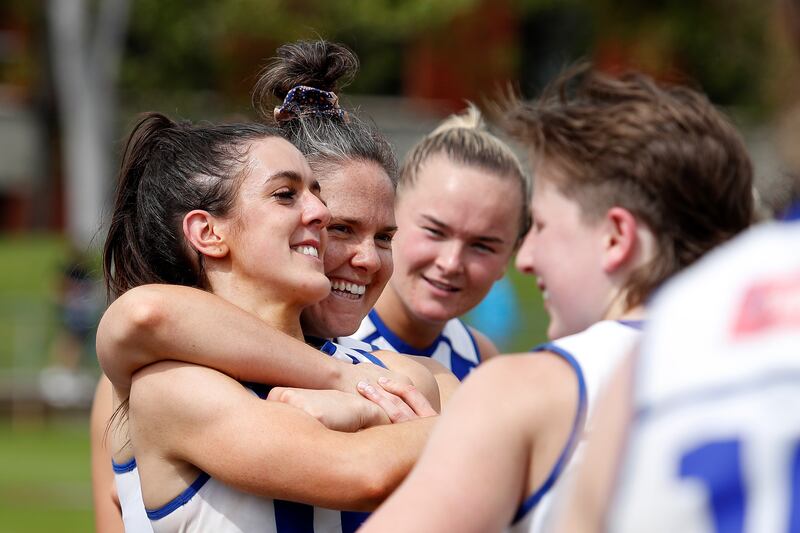 Erika O'Shea, Emma Kearney and Vikki Wall of the North Melbourne Kangaroos celebrate during the AFLW  match against the Collingwood Magpies  at Victoria Park in Melbourne, Australia. Photograph: Dylan Burns/AFL/via Getty Images 