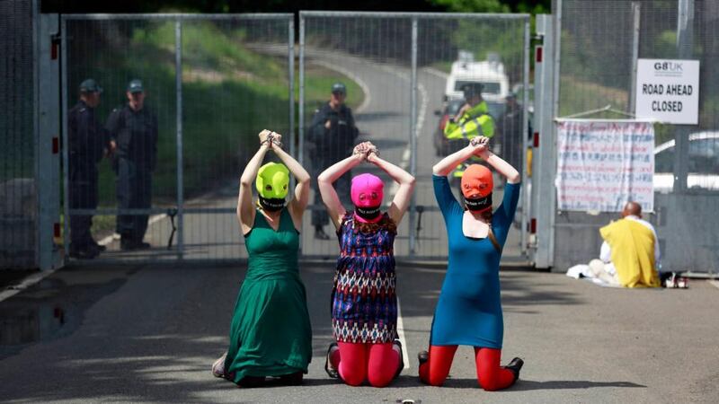 Demonstrators wear Free Pussy Riot balaclavas as they protest at the security fence surrounding the G8 Summit at Lough Erne in Enniskillen. Photograph: Cathal McNaughton/Reuters