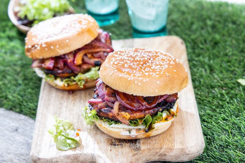 Gochujang glazed grilled chicken burger with tarragon aioli and sweet pickled red onions.