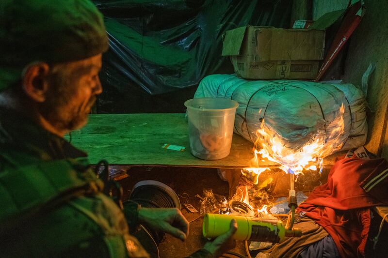 A member of Brazil’s environmental special forces team lights a mining cabin on fire during a mission to destroy illegal mining equipment in the Yanomami Indigenous territory of Brazil. Photograph: Victor Moriyama/The New York Times