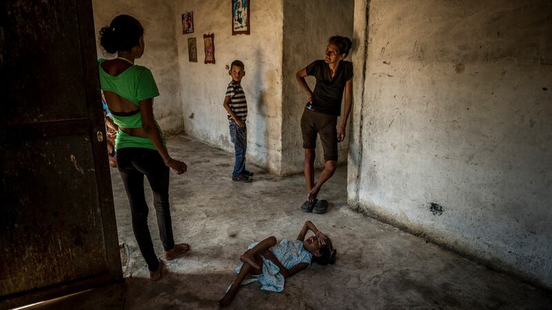 María Carolina Merchán (right), who weighs 30kg, with her daughter Marianyerlis Acosta (6) whose weight fluctuates between 9-13kg. Photograph: Meridith Kohut/The New York Times
