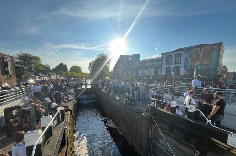 People sitting outside and socialising by the Grand Canal at the Barge Pub in the Portobello, Dublin near Charlemont Street Bridge.  Photograph: Bryan O’Brien