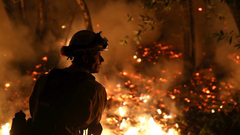 CalFire firefighter Trevor Smith monitors a firing operation while battling the Tubbs Fire in California. Photograph: Justin Sullivan/Getty Images