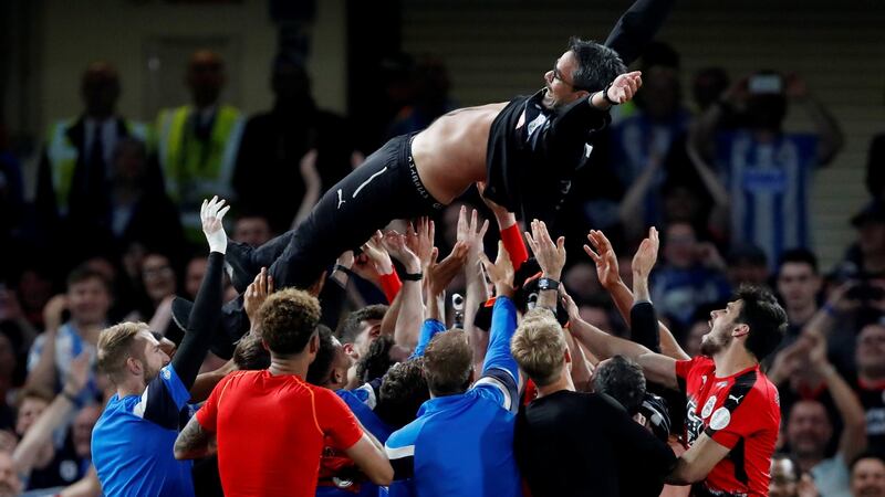 Huddersfield Town players throw manager David Wagner in the air as they celebrate staying in the Premier League at Chelsea’s  Stamford Bridge. Photograph: Matthew Childs