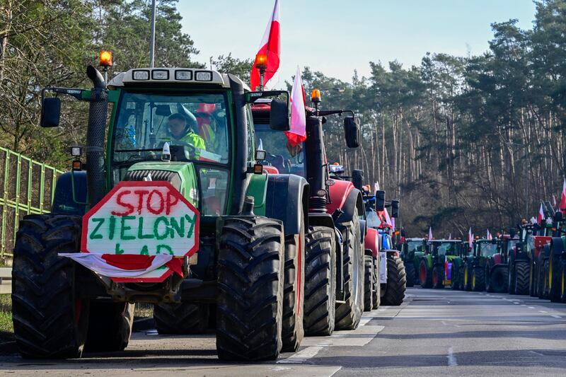 Farmers, one with a sign saying "Stop the Green Order", block the Poland-Germany border along the river Oder in eastern Germany on Monday. Photograph: John MacDougall/AFP via Getty Images