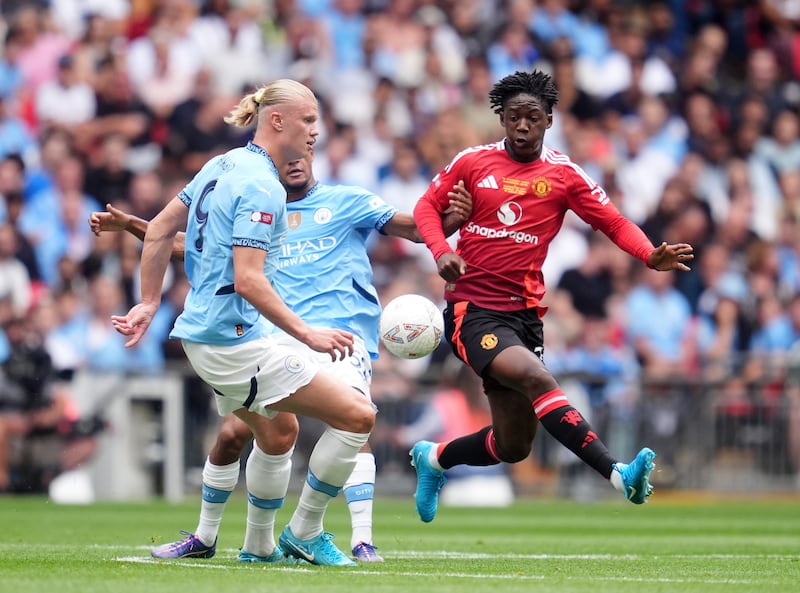 Manchester United's Kobbie Mainoo in action against Manchester City's Oscar Bobb and Erling Haaland during the FA Community Shield match at Wembley Stadium. Photograph: Adam Davy/PA