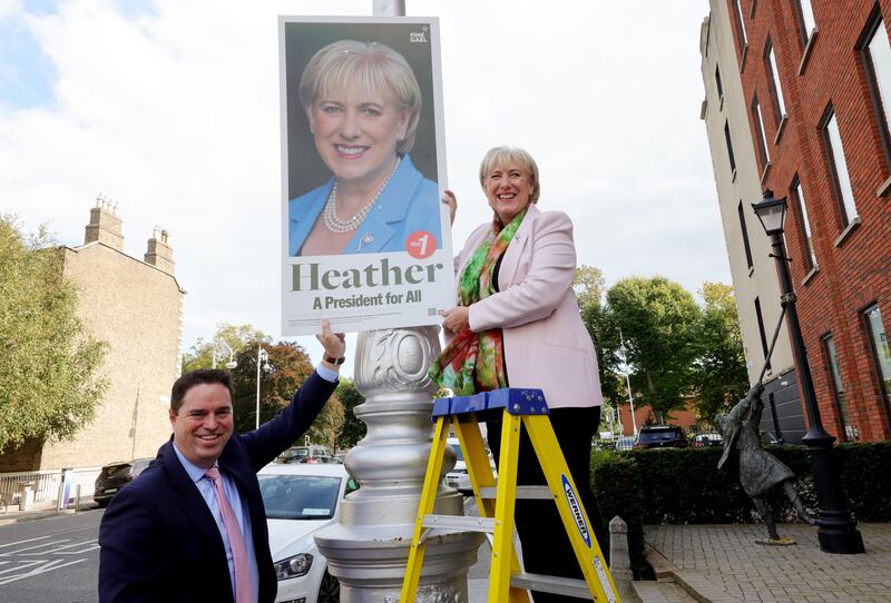 Heather Humphreys putting up a poster on Dublin's Mount Street assisted by Martin Heydon, Minister for Agriculture. Photograph: Alan Betson

