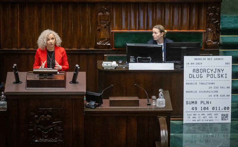 Polish minister for equality Katarzyna Kotula (left) speaks after putting up a mock-up invoice for how much money the Polish government owes to pro-choice organisations for securing abortions for women who needed it, at the Polish parliament in Warsaw on Thursday. Photograph: Wojtek Radwanski/AFP via Getty