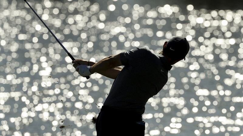McIlroy plays a drop shot from the 17th hole. Photo: Mike Ehrmann/Getty Images