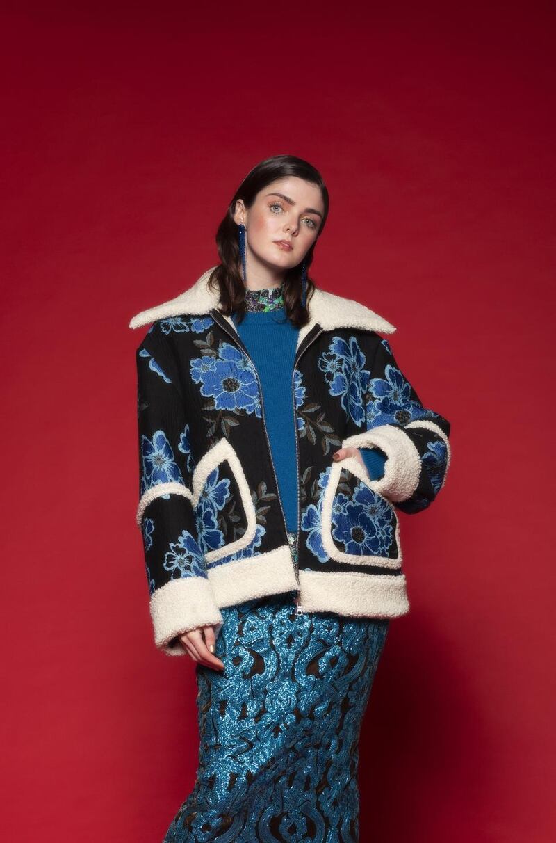 Blue drop earrings, €235, Simone Rocha, Havana, blue embroidered aviator jacket, €1,885, embellished midi skirt, €1190, both Dries Van Noten, Brown Thomas; knit blue jumper, €175, Solotre, Costume; floral blouse (worn underneath), €149, Essentiel Antwerp, Arnotts; knee-high boots, €545, Paris Texas, Brown Thomas
