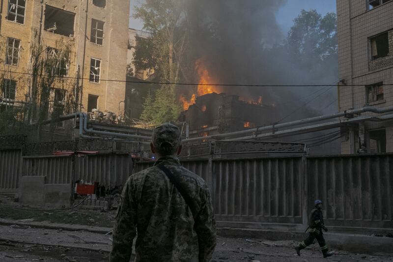 Firefighters and soldiers respond at the site of a Russian missile strike in central Kyiv on Sunday. Photograph: Mauricio Lima/The New York Times)