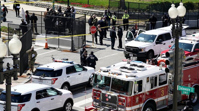 Police and fire officials stand near a car that rammed into a barrier on Capitol Hill in Washington on Friday. Photograph: J Scott Applewhite/AP