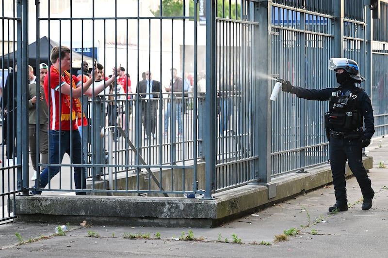 Police spray tear gas at Liverpool fans outside the stadium as they queue prior to the Champions League final against Real Madrid last May. Photograph: Matthias Hangst/Getty Images