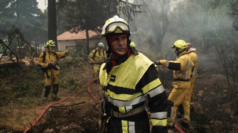 Firefighters from a French firefighting unit works to extinguish a wildfire in Afidnes, a suburb north of Athens. Photograph:  Nick Paleologos/Bloomberg