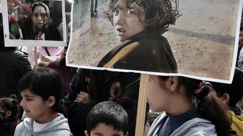 Children hold placards depicting young victims of the Syrian conflict, as they take part in a demonstration in front of the parliament in Athens on April 6th, 2013 in solidarity to Syrian refugees who fled the conflict in the country. Photograph: Louisa Gouliamaki/AFP/Getty Images