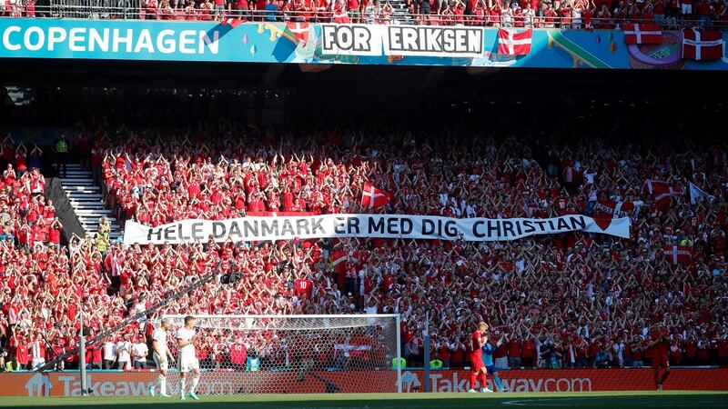 Denmark’s supporters clap and hold a banner in support of  midfielder Christian Eriksen during the  Euro 2020 Group B  match against  Belgium at the Parken Stadium in Copenhagen. Photograph:  Wolfgang Rattay/AFP via Getty Images