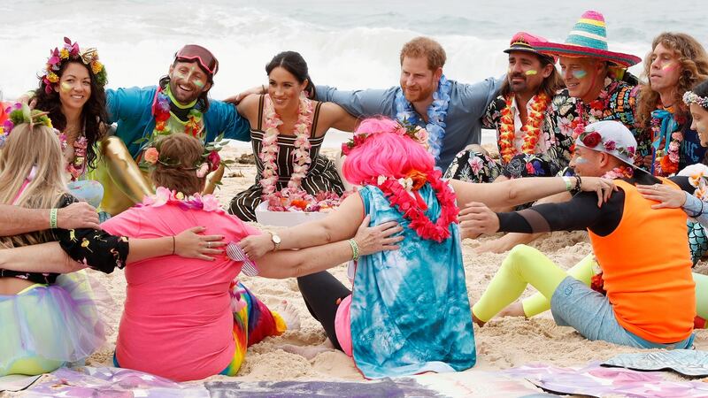 Prince Harry and Meghan take part in a group hug for mental health on Bondi Beach. Photograph: Chris Jackson/Pool/Reuters
