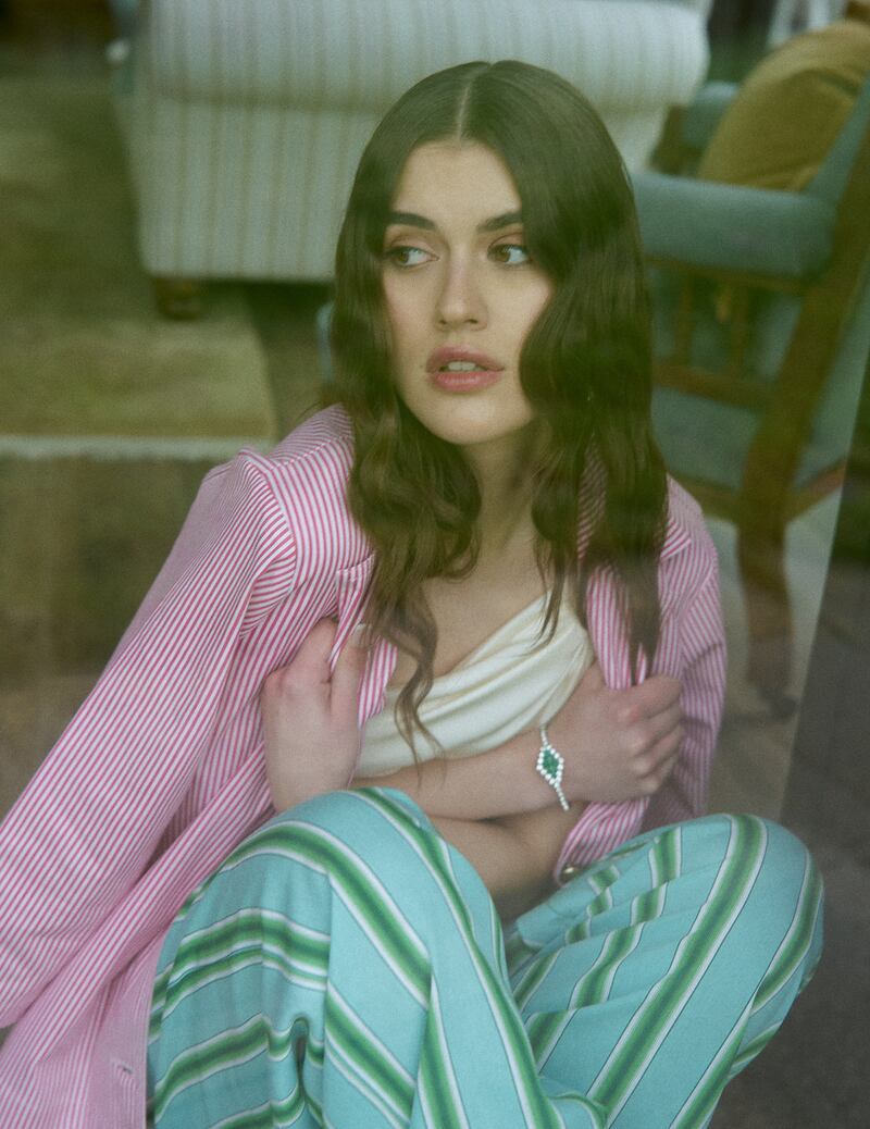 Red and white stripe jacket, €105, Bow & Pearl; one-shoulder top, Costume, €224; green striped trousers, Stella Forest at Costume, €140; jewellery, Jenny Vander