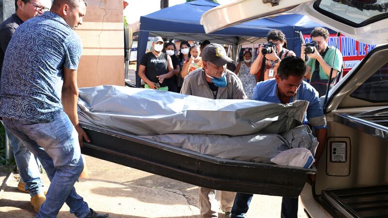 Funeral home employees carry  bodies after the riot in  Altamira. Photograph: Bruno Kelly/Reuters