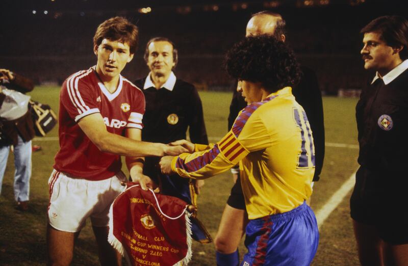 Bryan Robson admirers Diego Maradona's hair-do before the 1984 European Cup Winners' Cup quarter-final between Manchester United and Barcelona. Photograph: Trevor Jones/Getty Images