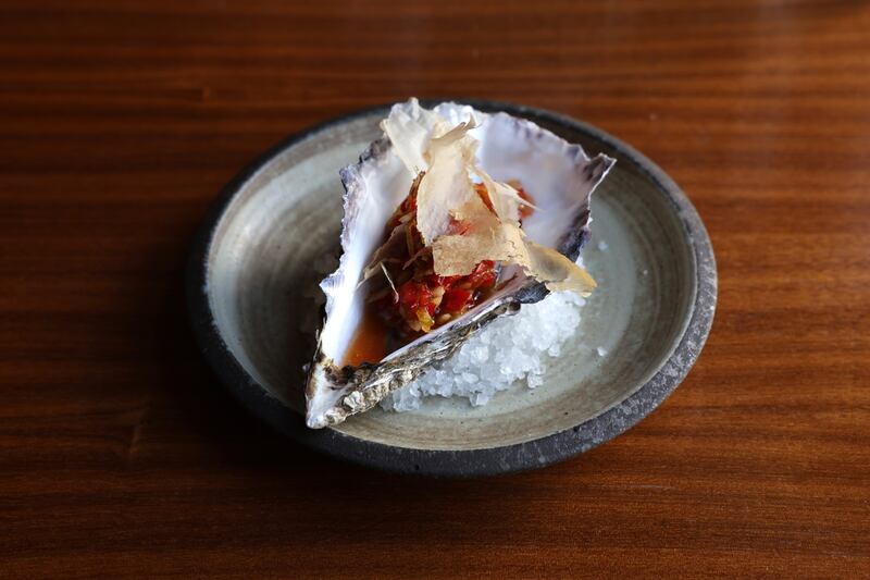 Oyster with nahm jim and a whispy flake of bonito. Photograph: Dara Mac Dónaill