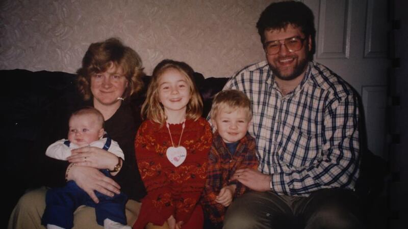 The Burke family in 1996: Amy Burke (centre) with her mother, Mary, holding her brother Michael, and her father Derek holding her brother David