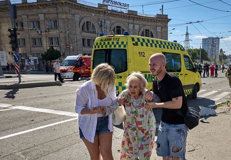 People help an elderly woman at the site of a glide bomb attack on a residential building in Kharkiv. Photograph: Sergey Kozlov/EPA