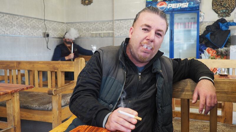 Locals in a tea shop in the Al-Nabi Younis neighbourhood of Mosul enjoy a smoke, an activity banned under Islamic State rule that would have earned them a lashing. Photograph: Lorraine Mallinder