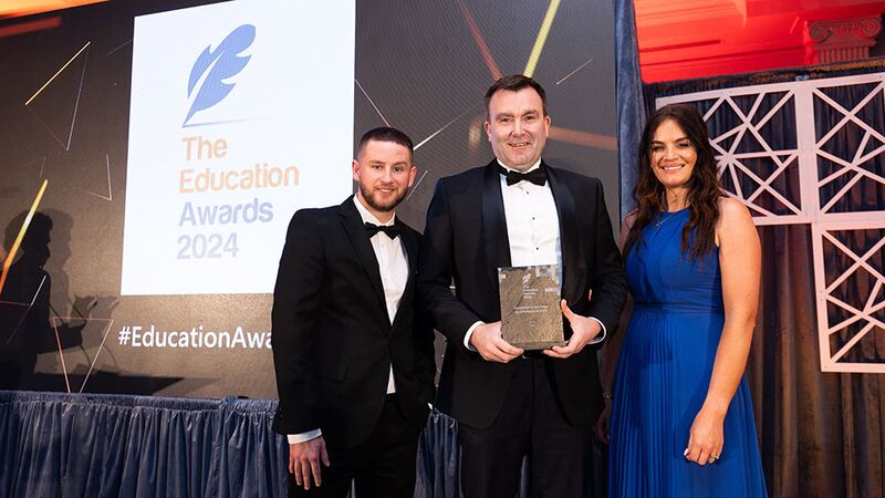 Adam Kane, community lead at Business River, presents the excellence in education by a professional body award to Paul Caroll and Eva Lavin, LIA