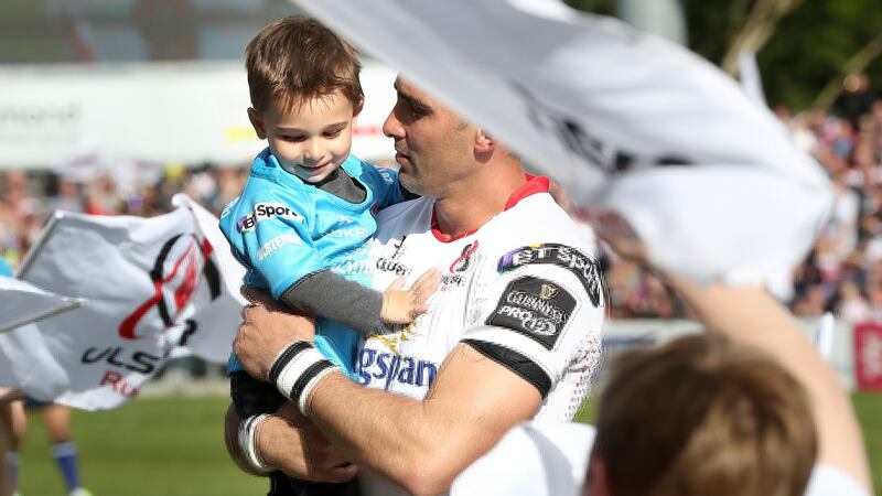 Pienaar with his son Jean-Luc before the game. Photo: Darren Kidd/Inpho