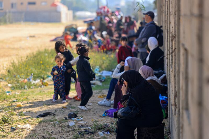 Residents of the Qatari-funded Hamad Town residential complex in Khan Younis in the southern Gaza Strip gatheron a street on Saturday as they prepare to flee their homes after receiving notification from the Israeli army of an imminent strike. Photograph: Mahmud Hams/AFP via Getty Images