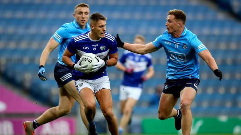 Laois’s Patrick O’Sullivan is challenged y Dublin’s Ciarán Kilkenny. The manner of Kilkenny’s goal summed up the gulf etween Dublin and everyone else.  Photograph: Ryan Byrne/Inpho