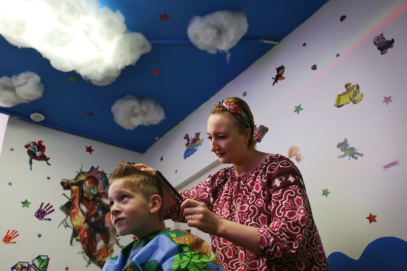 Maggie Radecka cuts Domick Gramza’s hair in the sensory room of her hair salon  'Cut & Fun' on Tyrconnell Road, Inchicore, Dublin. Photo: Bryan O Brien 