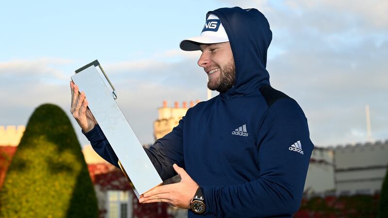 Tyrrell Hatton, wearing his hoodie, holds the winner’s trophy at the BMW PGA Championship at Wentworth last year. Photo: Ross Kinnaird/Getty Images