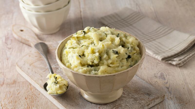 Colcannon potato mash in cream faceted bowl with metal spoon