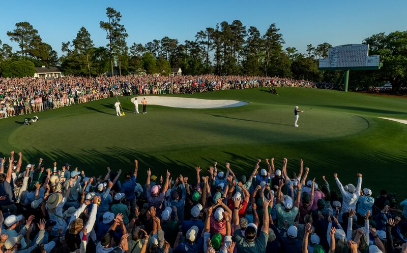 The scenes around the 18th hole as Rory McIlroy celebrates Masters victory at Augusta to finally complete his personal Grand Slam. Photograph: Augusta National/Getty Images)