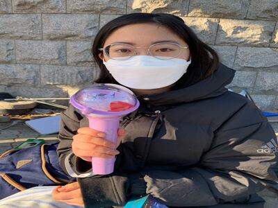 Jane Rhee (22), a student at Seoul National University, holds a torch that many protesters use on demonstrations. Photograph: David McNeill